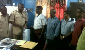 Head of G Division, Kevin Adonis (2nd left) makes the presentation  to Joshua Jones in the presence of other police and club officials.