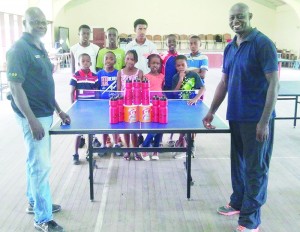 Howard James (right) and sponsor pose for a photo opportunity with some of the participants of the Linden Development Training Camp.