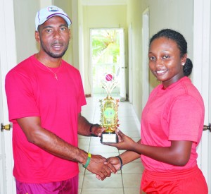 Player of the match Plaffiana Millington accepts  her prize from Berbice coach Andre Percival.