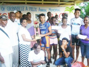 Paul DeNobrega receives his prize and the Grenville Felix Memorial Lien trophy from Joan Felix as the other winners and family members and organisers share the moment.