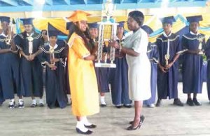 Top student Roxanna Singh receives a trophy from her Deputy Head Teacher.    