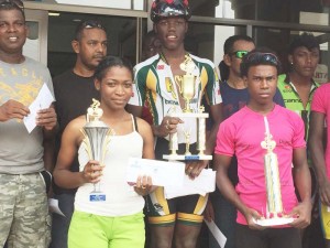 In picture the three category winners Marica Dick, overall winner Romallo Crawford and Balram Narine  pose with other recipients after the race.