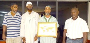 President of the Guyana Judo Association, Raoul Archer (2nd r) proudly displays the plaque that inducts the local Judo body into the ITF Hall of Fame. Also in picture are l-r, William Arthur (extreme L), Imam Naeem Muhammad (2nd L) and Hilbert Archer (extreme R).   