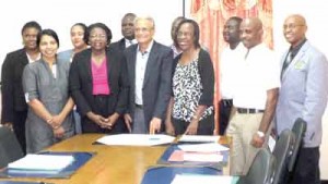 Minister of Education, Dr Rupert Roopnaraine and Vice Chancellor, Professor Jacob Opadeyi, flanked by the recipients of grants.