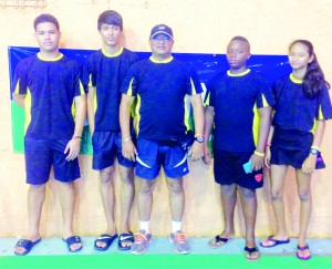  Guyana’s Under-19 Badminton team that participated  in the CAREBACO Championships. From right, Priyanna  Ramdhani, Tyrese Jeffery, Gokarn Ramdhani (Coach),  Narayan Ramdhani and Jonathan Mangra. 