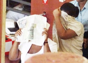 Jacqueline and Ayesha Rodriques  being escorted by a Police Officer at  the Georgetown Magistrates’ Court.