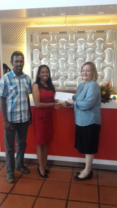 From right GM Ms. Susan Isaacs hands over sponsorship cheque to Ms. Vidushi Persaud in the presence of Mr. Ryan McKinnon.