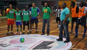 GT Beer Manager Geoff Clement (centre) about to kick off the ball to signal the start of competition on Tuesday evening, at the Cliff Anderson Sports Hall.