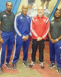 Abdullah Hamid (left), Stanley Lancaster (2nd left) and Trevor Beckles (right) with one of the officials during the programme. 