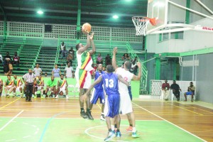 Colts’ Centre, Shane Webster goes up  for an uncontested floater in the paint  Wednesday night in the first semi-final  of the GABF Forbes Burnham Memorial  Basketball Championships at the  Cliff Anderson Sports Hall.