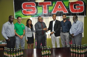 Ansa Marketing Executive Troy Cadogan (4th left) hands over the cheque to GFF Normalisation Committee Chairman Clinton Urling in the presence of Company officials and GFF representatives yesterday.