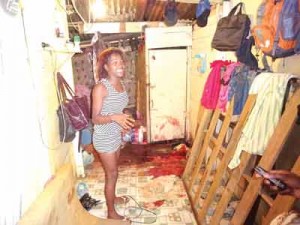 Tawana Clark is overcome with grief as she stares at the blood stained interior of her mother’s shack.   