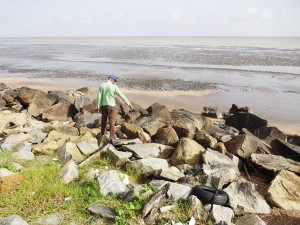 A man points to the spot where the body was found.  