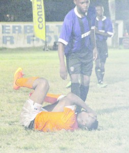 Conquerors’ Eon Alleyne is in obvious pain after sustaining an injury.