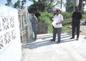  M&CC officials engage a resident at the community outreach, last week. 