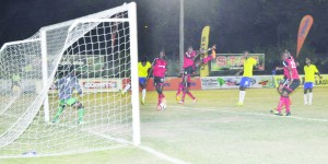 Pele’s Gregory Richardson (2nd left) heads the ball into the goal to put his side ahead against Alpha United. 