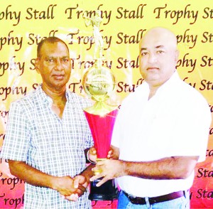 Managing Director and Proprietor of Trophy Stall Mr. Ramesh Sunich (left) hands over one of the trophies to President of Lusignan Golf Club Mr. Oncar Ramroop.