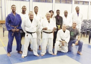 Joseph Edmondson (centre front row) displays the certificate he was given by the Rising Sun Judo Club in recognition of his sterling contribution.