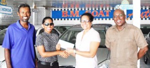 Mrs. Priya Mohamed (right) of B.M. Auto Sales hands over sponsorship funds to GSSF President, Ms. Vidushi Persaud (2nd left) in the presence of GSSF Secretary, Mr. Steve Ninvalle (right) and Assistant Secretary/Treasurer, Mr. Ryan McKinnon (left).