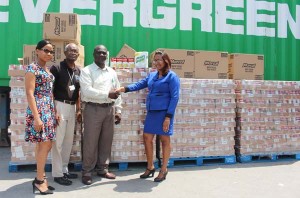 In this photograph Carib Foods Operations Manager Kharishma Narine-Foo hands over the donation to Food for the Poor Chief Financial Officer (CFO) Aubrey Austin ( center), in the company of Astacia Abel and Wayne Hamilton of FFTP Donor Relations and Public Relations Departments, respectively.