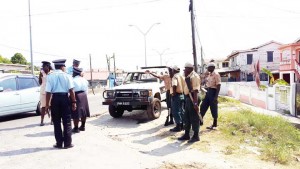 Police and private security ranks surround the MMC security vehicle that had overturned.  