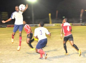 This Monedderlust player is airborne as he heads the ball away keenly watched by teammate Dane Johnson (#3) and Buxton’s Clive Andries (2nd left) and Rondell Assanah (#4).   