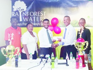 Banks DIH Water Brand Manager Errol Nelson (third, left) hands over the sponsorship deal to AAG President, Aubrey Hutson yesterday in the presence of other AAG officials at his office in Alberttown.