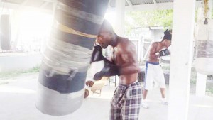 Quincy Gomes pummels the heavy bag during training sessions Wednesday afternoon.