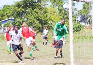 Agricola’s Captain Brian Price nets the first goal of the league against KK Warriors’ goalkeeper, Sherven Henry.