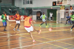 Barbers Association goalscorer John Abrahams (backing camera) unleashes a powerful sot during their encounter against Bounty Farm Ltd.