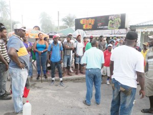 Morian (at right, with paper in hand) calls out the names of persons involved in the clearing exercise.