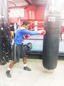 Clive Atwell pummels away at the heavy punching bag during preparations at Gleasons gym.