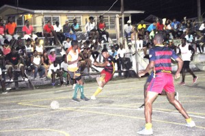 Silver Bullets’, Dion Charters (second, left) blasts a missile pass his defender for one of his two goals in the NEE Stag/ Cell Smart Futsal Semi-Finals Saturday night in Linden. 