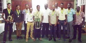 Members of the GCC team with Clive Lloyd(center) and Roger Harper fourth from right. 