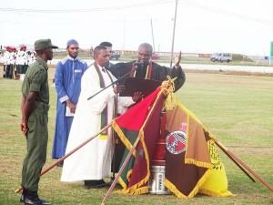 GDF Chaplain Reverend Nicholas Corbin supported by Pastor George Jeffers, assistant force Chaplain prays for the five unit flags and their ranks seeking direction and protection from the almighty in the company of Pandit Dhanesh Prashad and Brother Asheel Khan. 