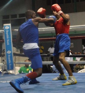 Guyana’s Clairmonte Gibson breaches the defence of Dominican Simon Joseph in Elite Bantamweight Semi-final. (Sean Devers photo)