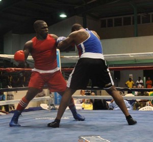 Guyana’s Eon Frazer about the land a powerful right hand on Christopher Andell in thier Elite Heavyweight semi-final (Sean Devers photo)