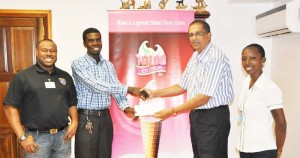 Managing Director of Sterling Products Ramsay Ali (2nd right) hands over the sponsorship to Petra’s Mark Alleyne in the presence of Co-Director Troy Mendonca and Women’s Football Association President Charmine Wade yesterday. 