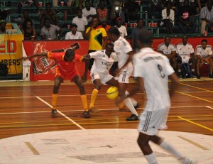 Part of the action in the final between eventual winners Banks DIH (red uniforms) and Ministry of Foreign Affairs. 