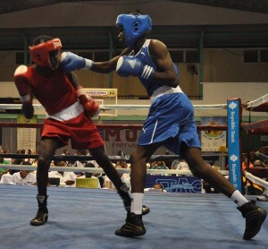 Jamaican Daniel Hylton scores with a right cross to the head of Guyanese Christopher Moore in their Juniors Featherweight semi-final. (Sean Devers photo)