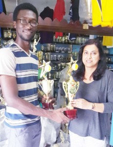 PRO Jamal Goodluck (left) collects some of the trophies from Trophy Stall co-owner Devi Sunich. 