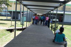 Several students stroll along the catwalk at UG.