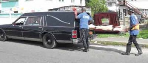 Undertakers from the Lyken Funeral Parlour removing a body from a crime scene. 