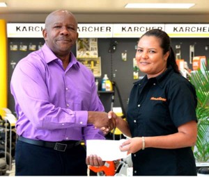 Flex Night Managing Director, Donald Sinclair receives contribution from Melisa Gounga-Khan, Store Supervisor of Farfan & Mendes.