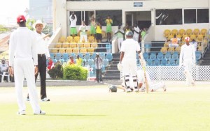 As umpire Wilson signals four and his team mate celebrate his ton Assad Fudadin is on the ground giving thanks to Allah. 