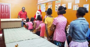 Digicel Brand Ambassador, Christopher Barnwell with some of the children of the Sophia Care Centre.