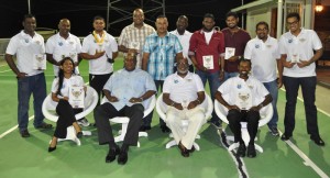 Chief of Staff of the GDF, Brigadier Mark Phillips (seated 2nd left), IPSC Regional Director (Guyana) Harold Hopkinson (seated 2nd right), Vidushi Persaud (left) and Ryan McKinnon (right) along with the other awardees following the presentation of awards. 