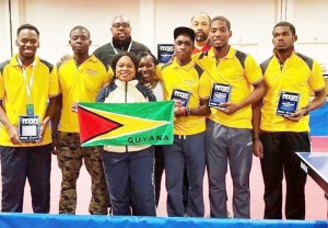 Guyana’s Division III Gold Medal Table Tennis Team poses for a photo opportunity at 2015 US Open Championships with supporters. From left: Orlando McEwen, Coach, Idi Lewis, Darwin Walcott, Shawn Abrams, Dianne Chance, Suzanne Plummer, Nigel Bryan, Shemar Britton and Joel Alleyne.