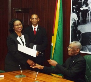 Appointed: Acting Chief Justice Yonette Cummings-Edwards collects her appointment from President David Granger after being sworn in yesterday.