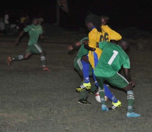 Veteran Kings player Winston Pompey (#6) battling Stewartville’s Rickford Albert (#1) and others for possession on Friday night at the Victoria ground.